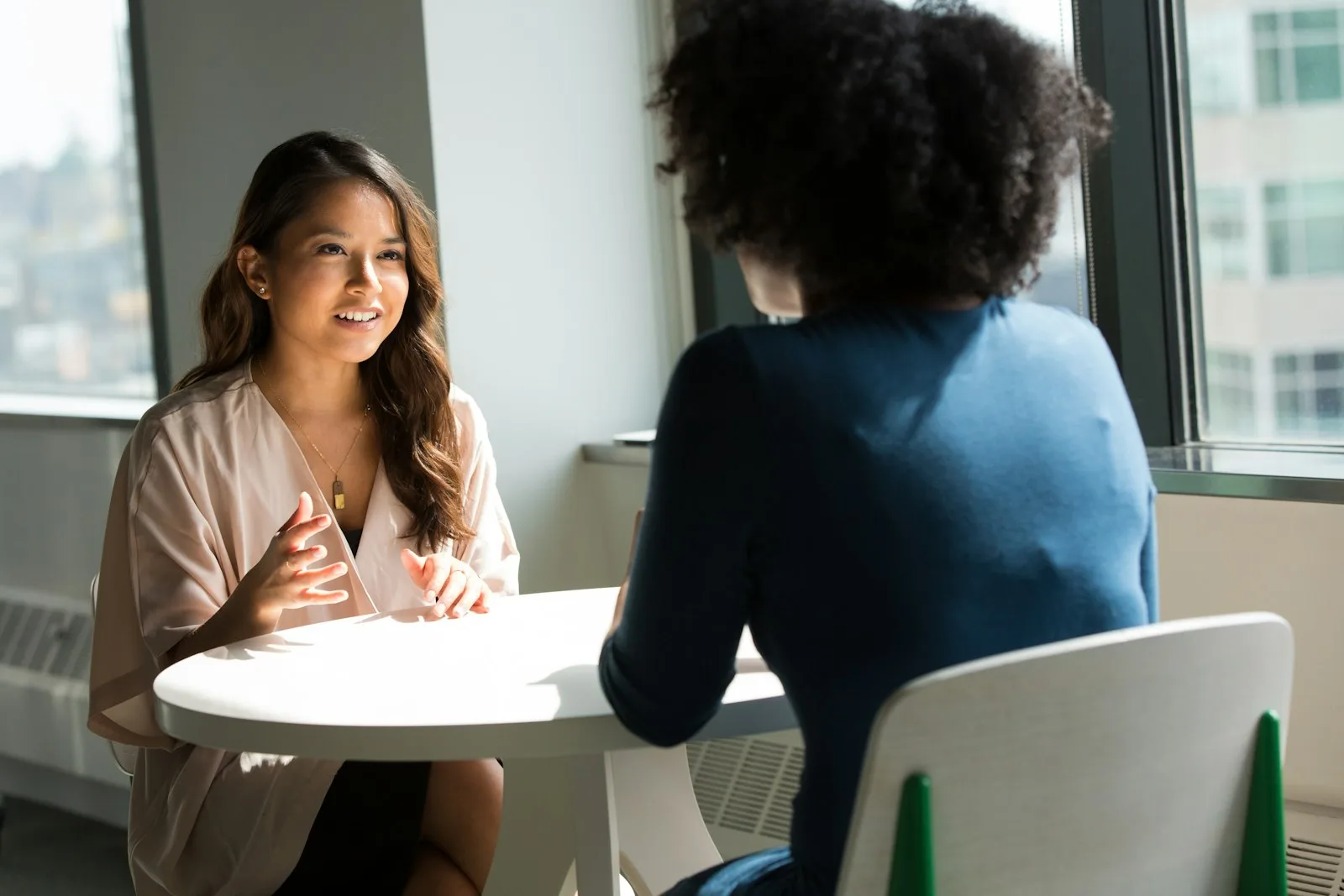 Operating partners talking through a decision in a high-rise office